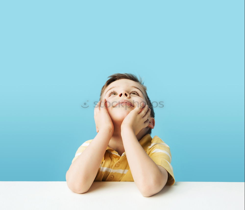 smiling baby with an orange on blue background