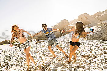 Happy best friends having good time on the beach together