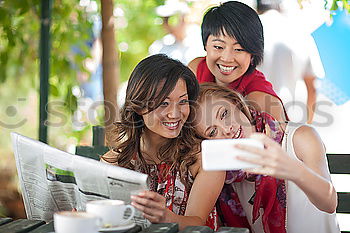 Similar – Young happy couple using smart phone sitting in the park