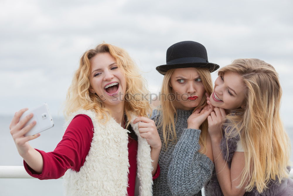 Similar – Two girls sitting on the bench and smile