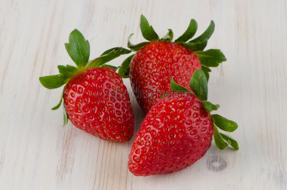 Similar – Strawberries whole and cut on a white wooden table