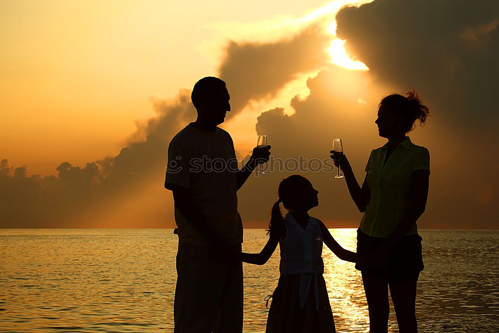 Similar – Mother and son holding hands on a beach at sunset