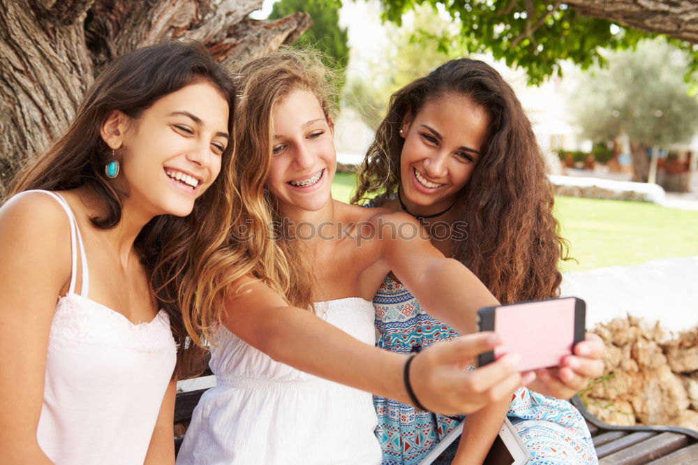 Similar – Beautiful women taking a selfie portrait in park.