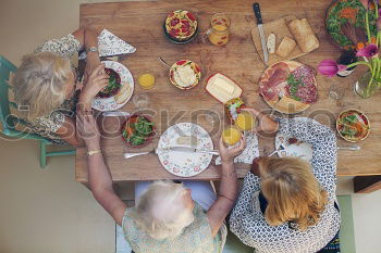 Similar – Group of People enjoying food and wine at restaurant