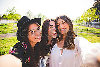 Similar – Beautiful women taking a selfie portrait in park.