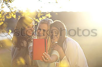 Similar – Beautiful women taking a selfie portrait in park.