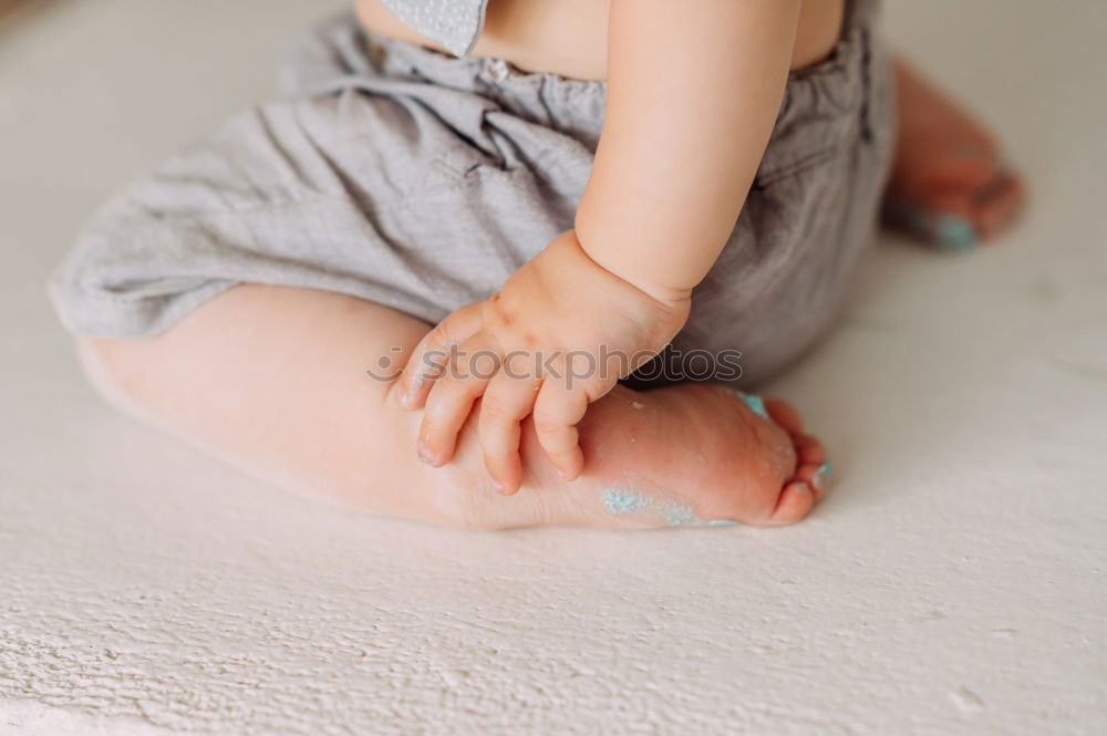 Similar – Little girl putting on her socks