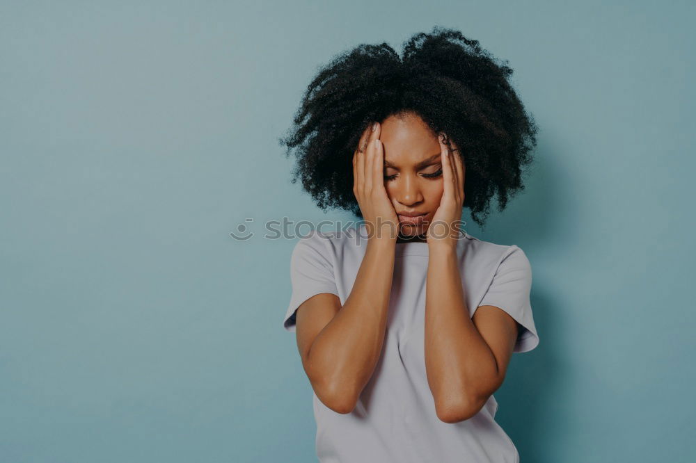 Portrait of beautiful afro woman covering her face.