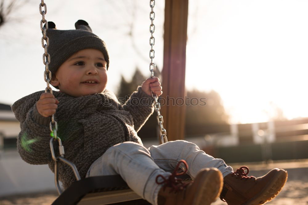 Similar – Cute caucasian siblings sitting on slide on playground