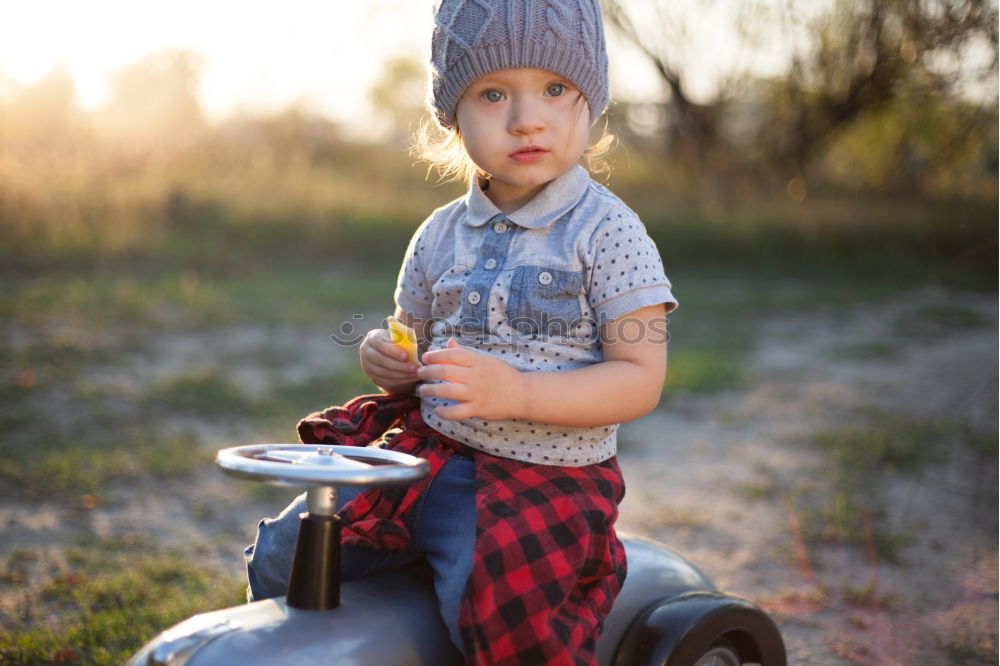 Similar – Child playing with toy tractor on meadow