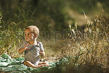 Similar – Cheerful kid in costume posing on tree