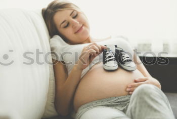 Pregnant woman touching her belly