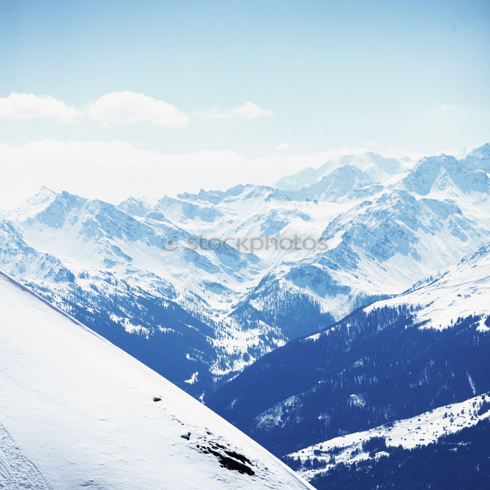 Similar – Sun loungers in the snow in front of mountain panorama