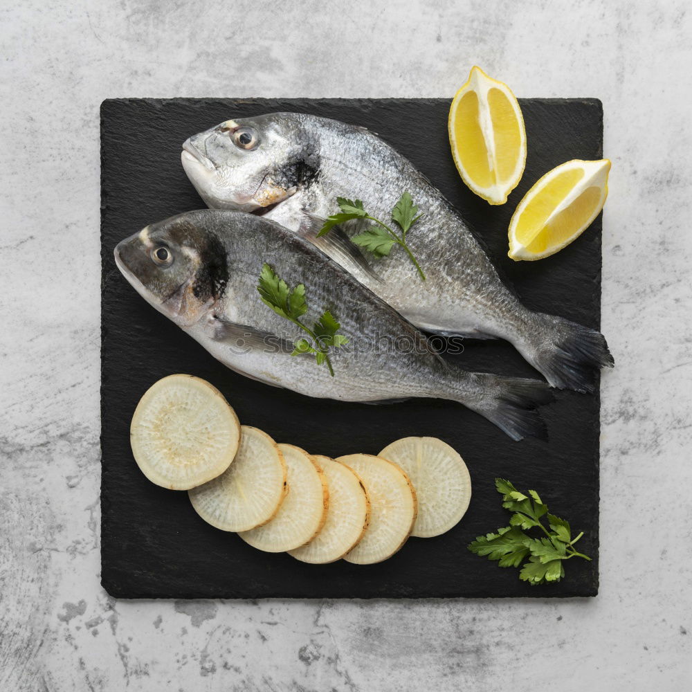 Similar – Image, Stock Photo Sea bass on kitchen table with lemon and rosemary