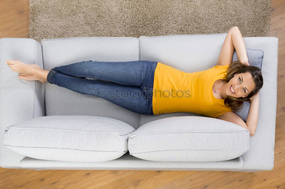 Similar – young, tall, leggy woman sits barefoot on a light couch