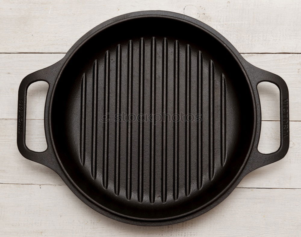 Empty grill pan with wooden spatula and spoon