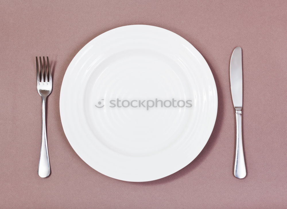 Similar – White empty plate and metal vintage knife and fork