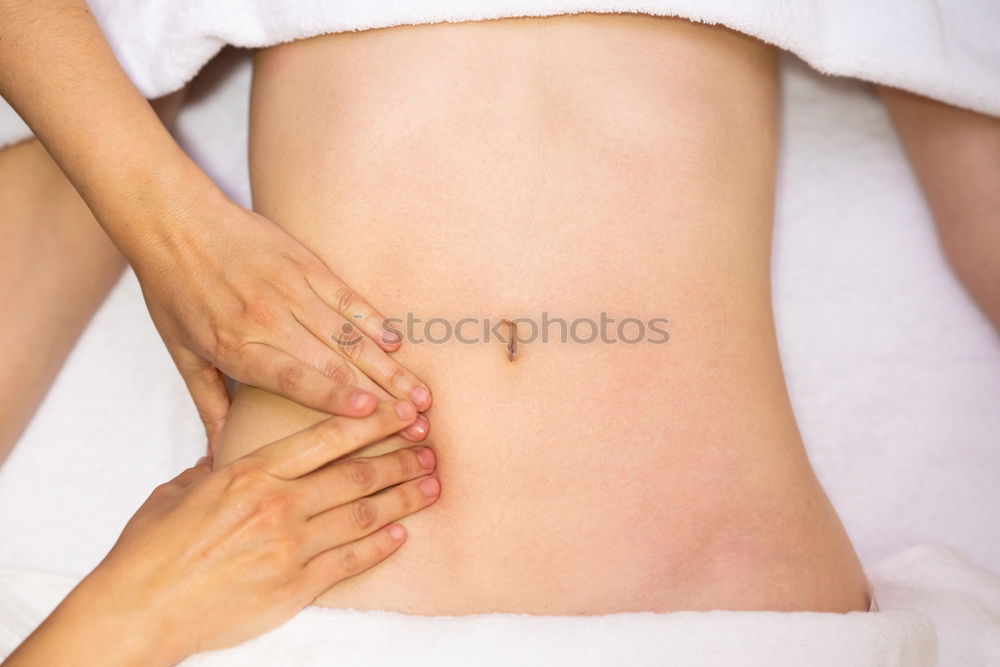 Similar – Hands massaging female abdomen.