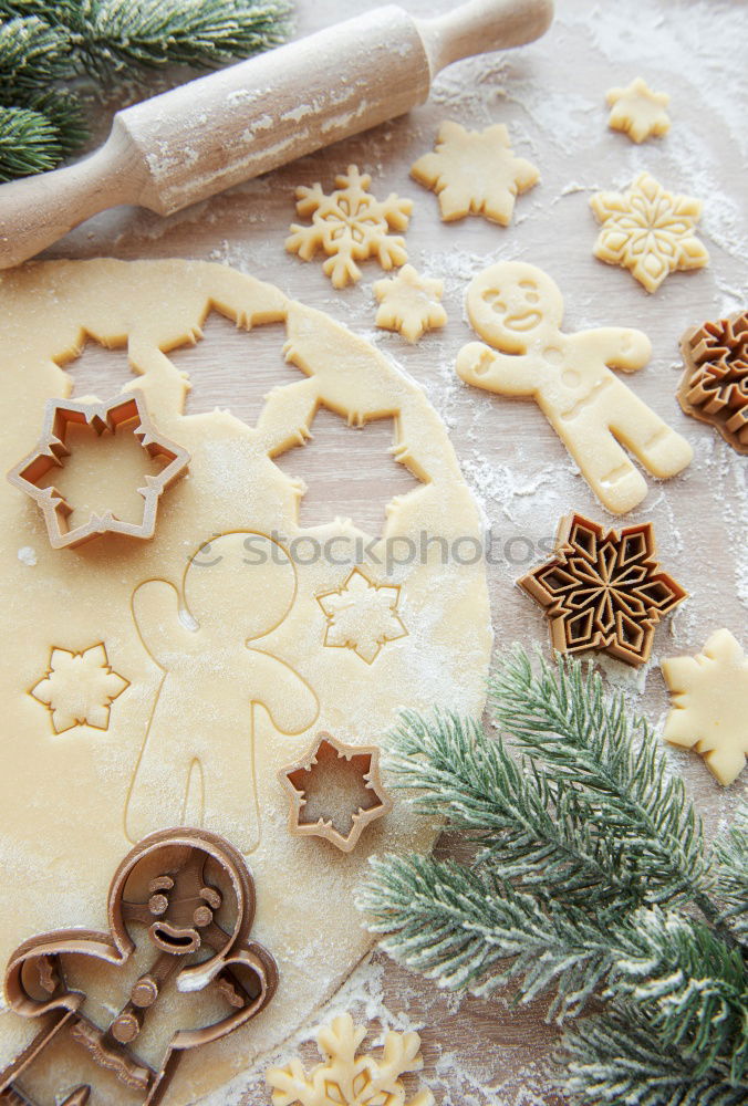 Similar – Cooking Christmas cookies with cookie cutters on a dark table