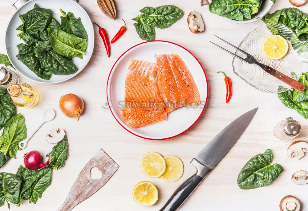 Salmon with spinach on a white kitchen table