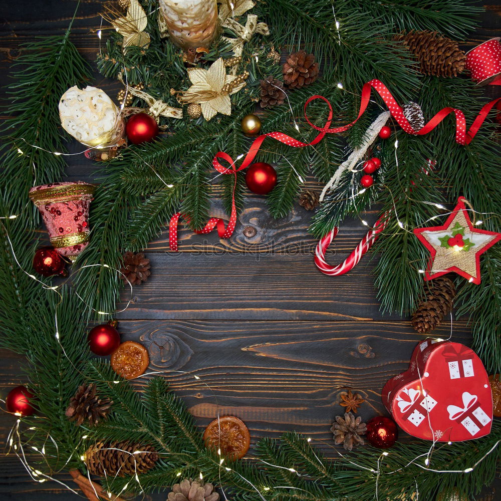 Similar – Rustic, beautiful Christmas decoration with twigs and a Christmas tree ball, on an old vintage table in winter during the Advent season. Christmas decorations with flower pot, tea light, glass vase, plants, cuttings on old stove, outside in the cold, icy garden.