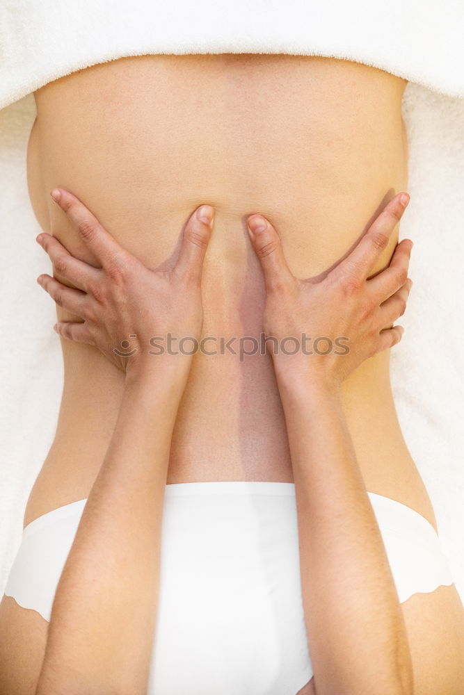 Similar – Hands massaging female abdomen.