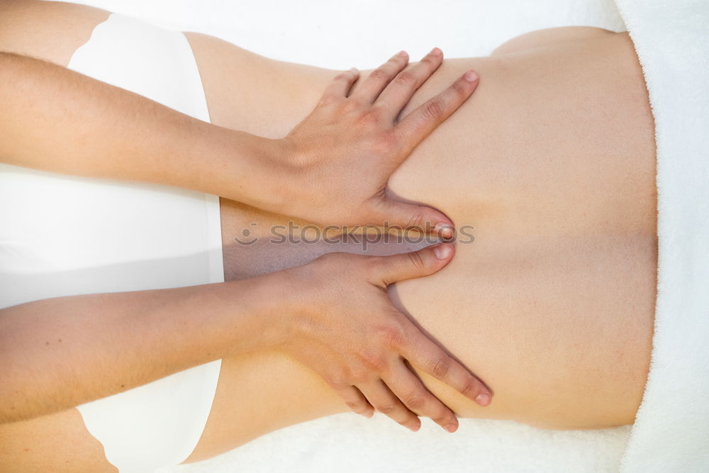 Similar – Hands massaging female abdomen.