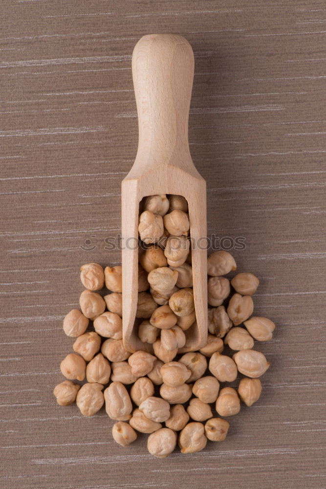 Soy beans on wooden spoon and wooden table