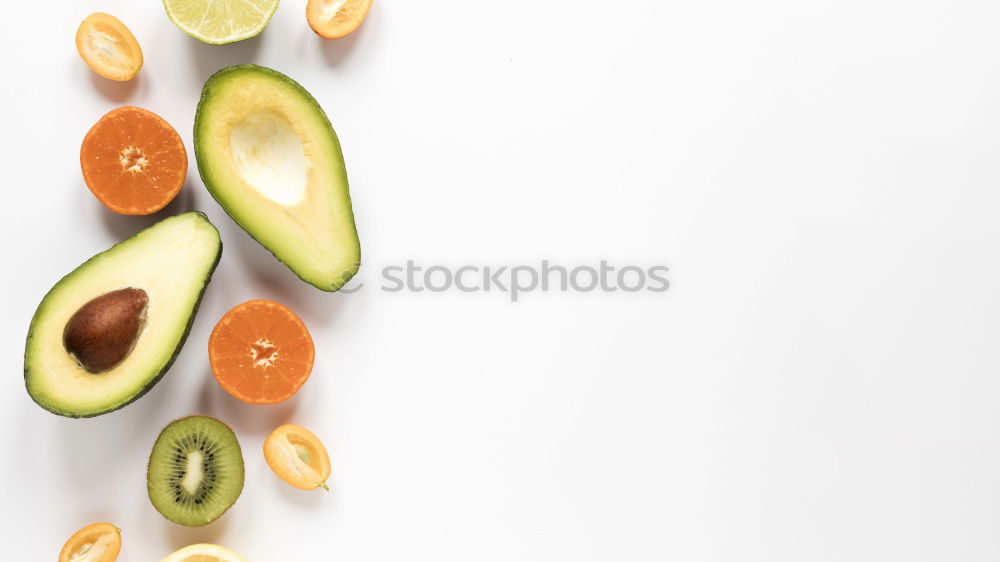 Similar – Cut avocado on white plate on pastel background