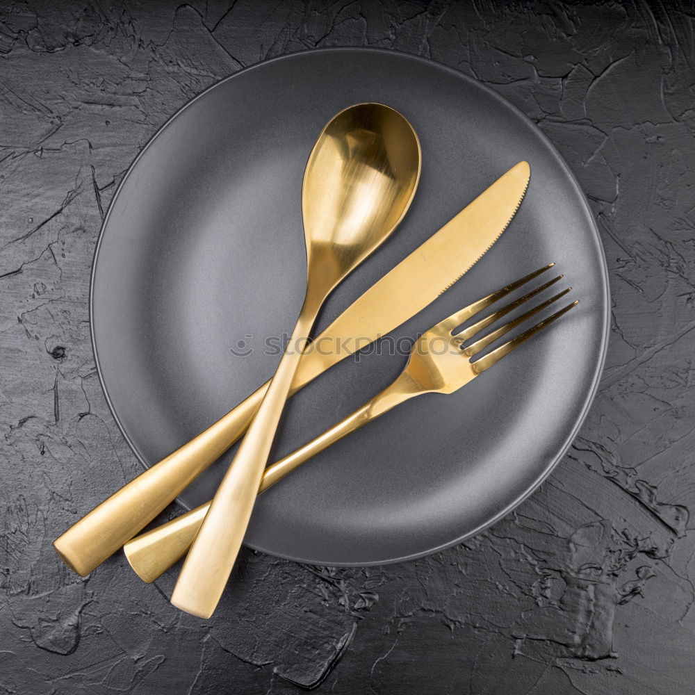 Similar – Spoon and fork on the plate framed with spices