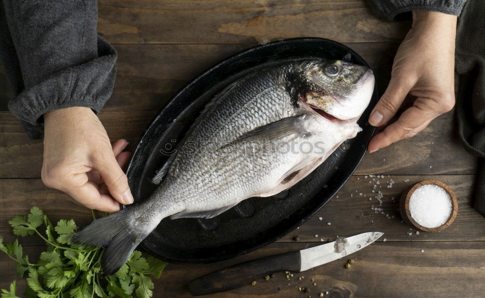 Similar – Tying a rope on fish for grilling