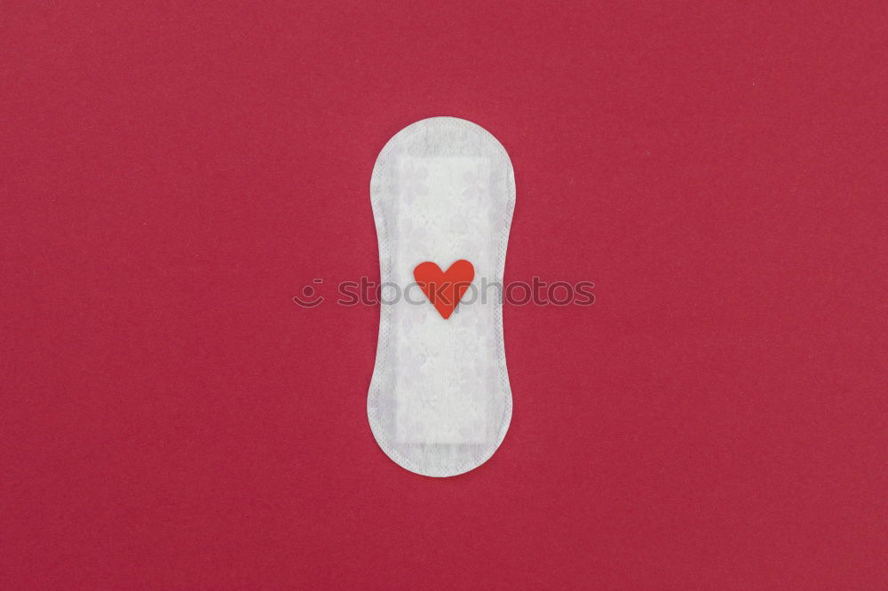 Similar – Tampon moving towards red painted spot. Menstruation, blood, period, menstrual flow.