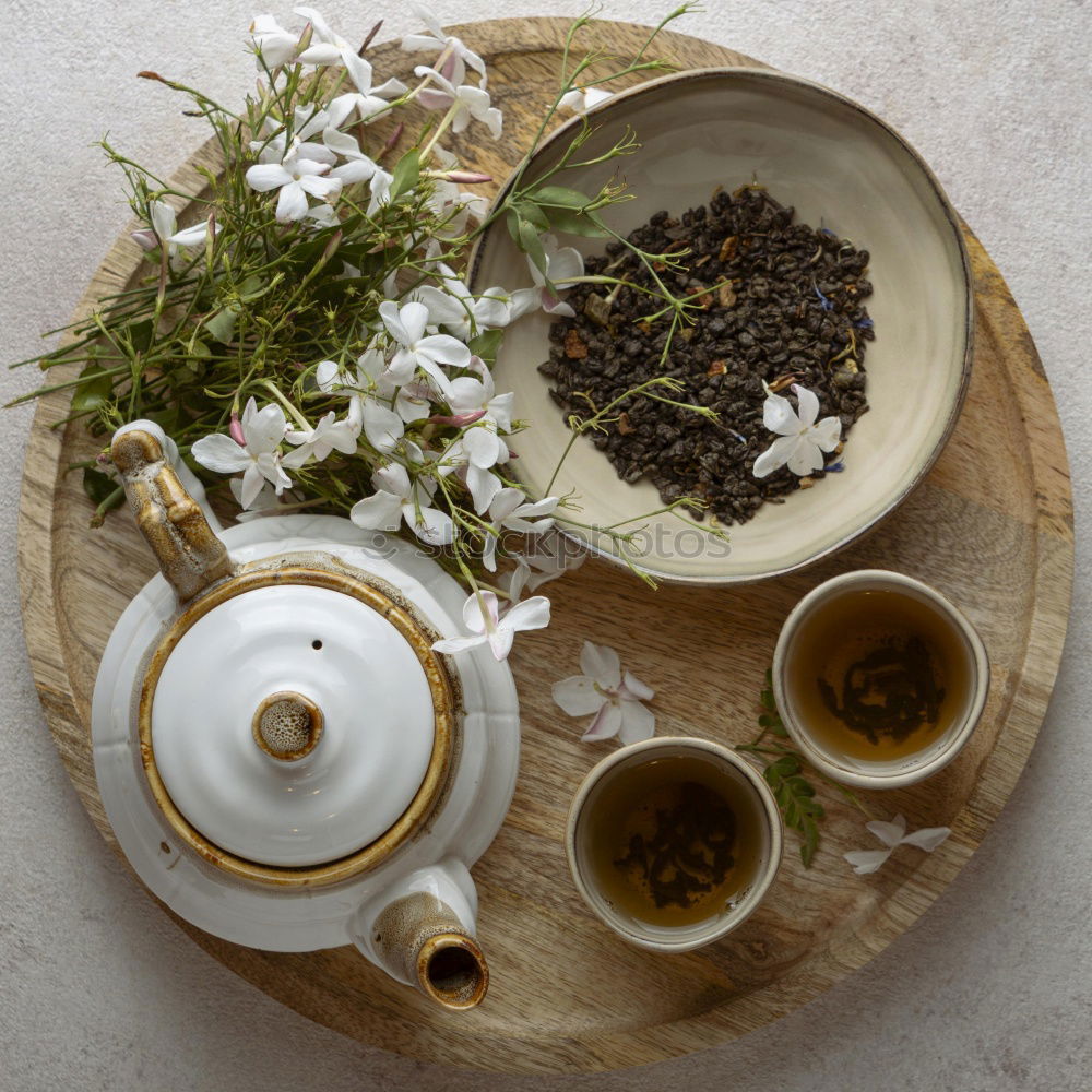 Similar – Black tea with jasmine in a white cup on a brown wooden table