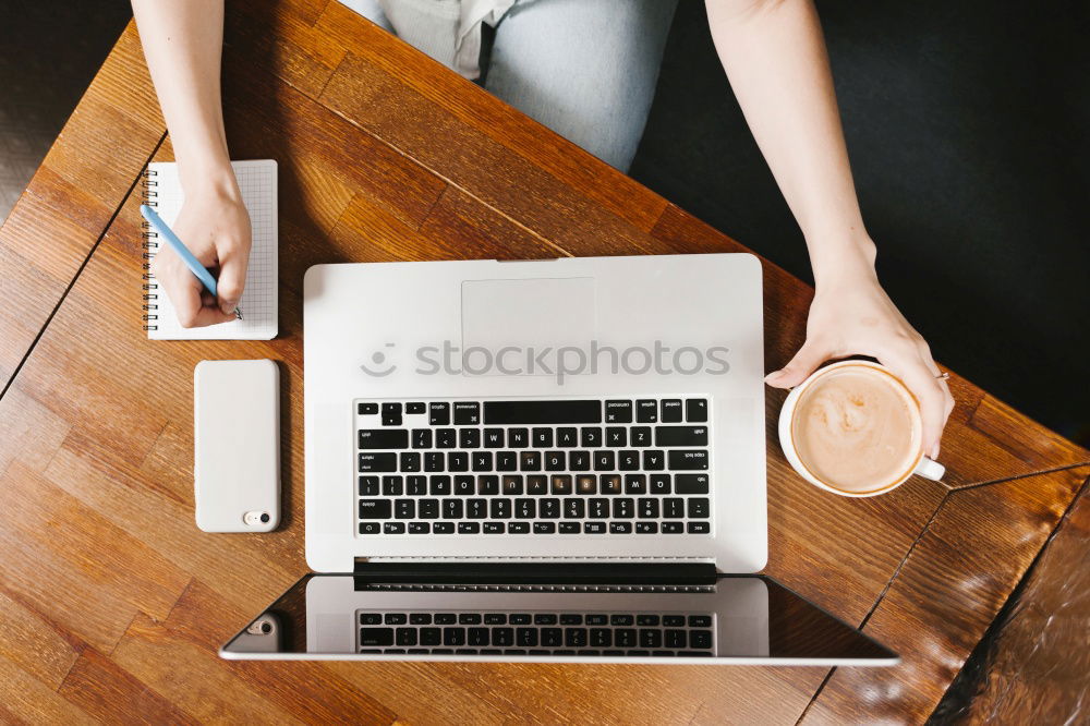 Similar – Young adult woman working on laptop in cafe