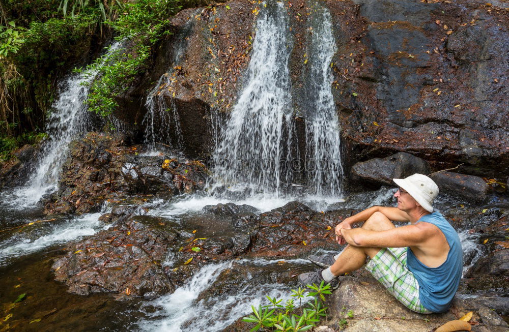 Similar – young woman standing in front of tropical waterfall