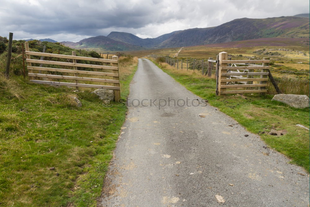 Similar – Fence on road in hills