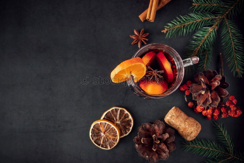 Cup with mulled wine and Christmas decoration