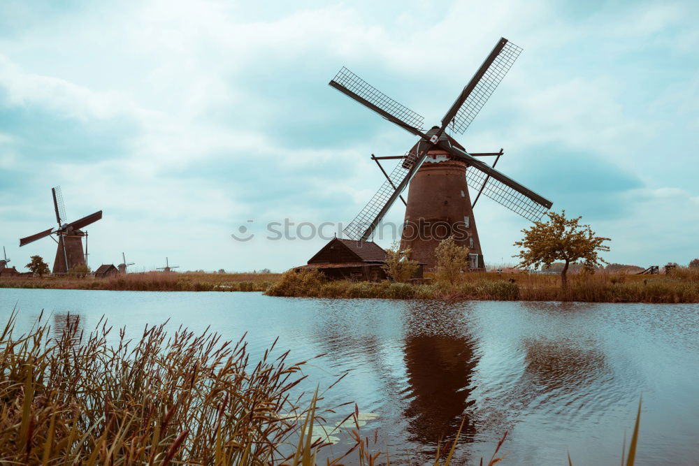 Similar – charming windmill by river at sunrise