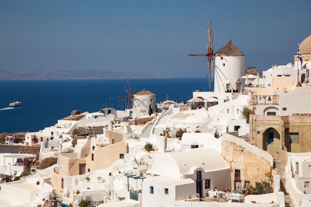 Similar – Image, Stock Photo Idyllic white houses on Santorini with windmills in front of blue sky