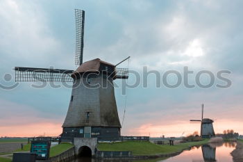 Similar – charming windmill by river at sunrise