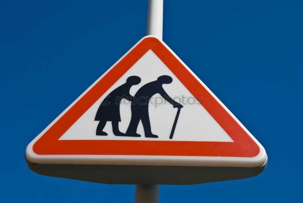 Warning sign: Attention! Old people cross the street