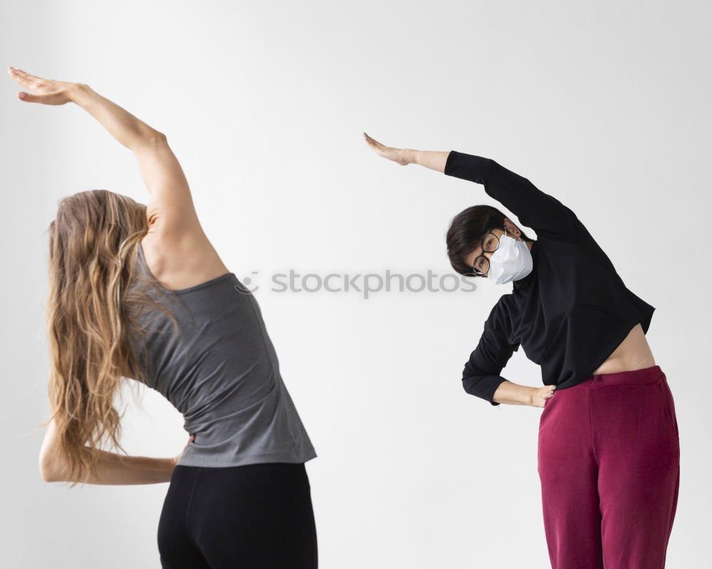 Similar – Group of young sporty attractive women in yoga studio, practicing yoga lesson with instructor, standing, stretching and relaxing after workout . Healthy active lifestyle, working out indoors in gym