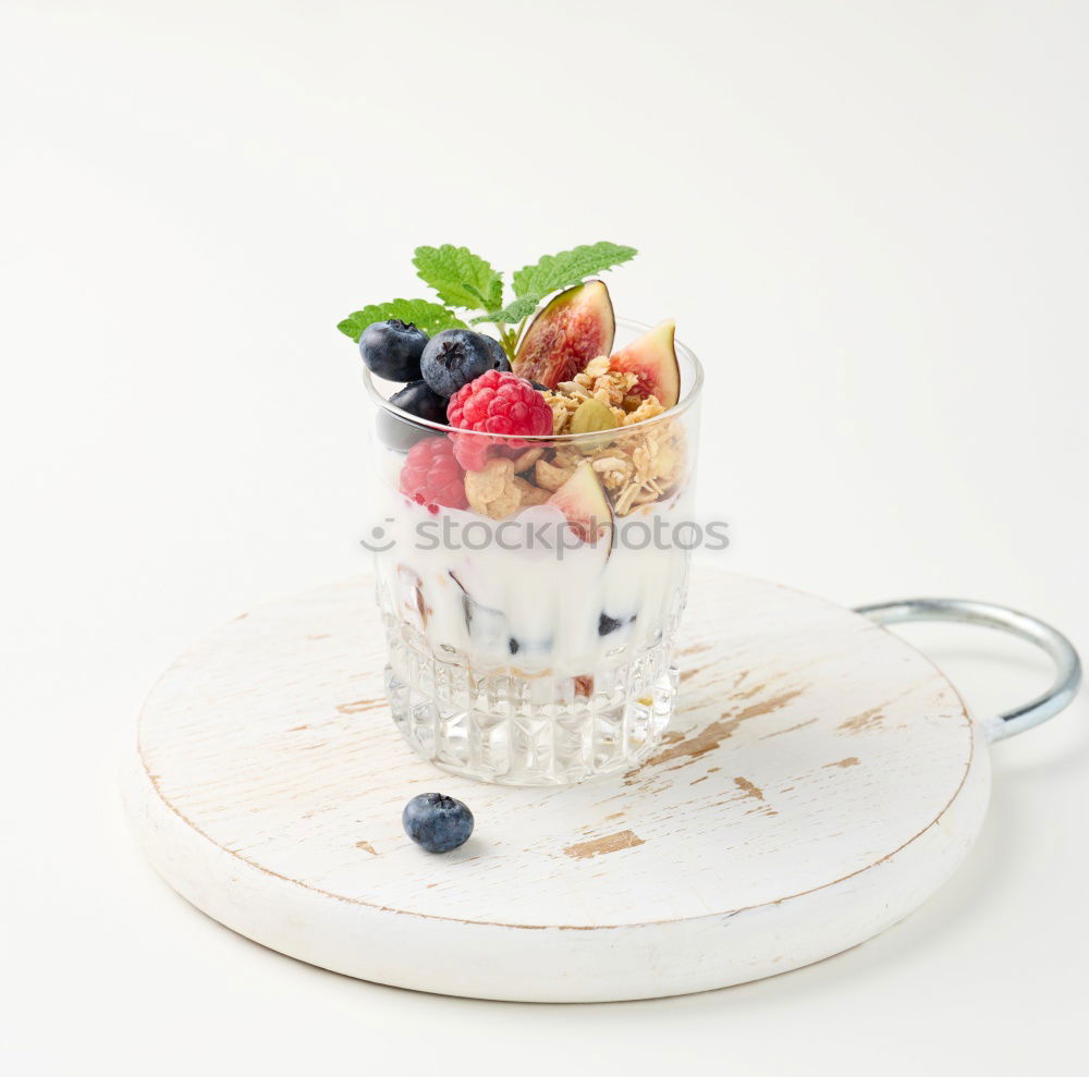 Similar – Berry-fruity water, iced with raspberries, blueberries, ice cubes and drinking straw on white background