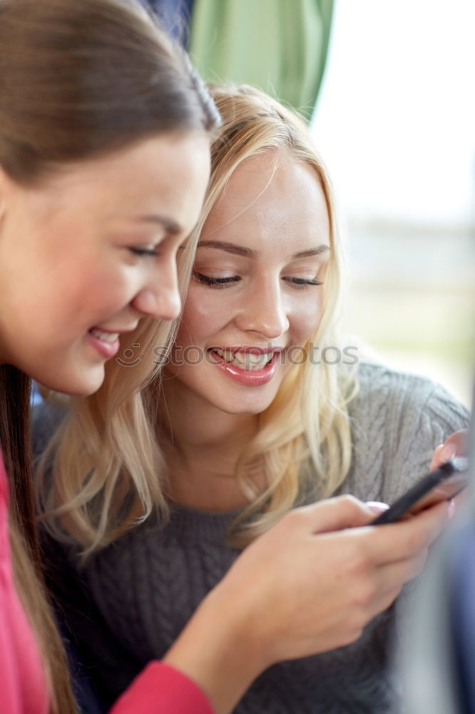 Image, Stock Photo Young women using mobile phones watching music clip, texting, messaging. Teenagers using the smartphones, sitting on sofa at home. Using technology devices. Girls wearing summer clothing