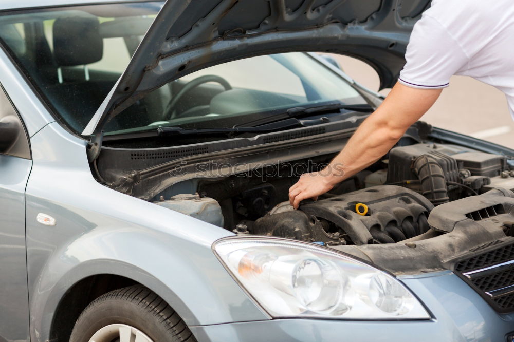 Similar – Professional Mechanic Repairing Car.