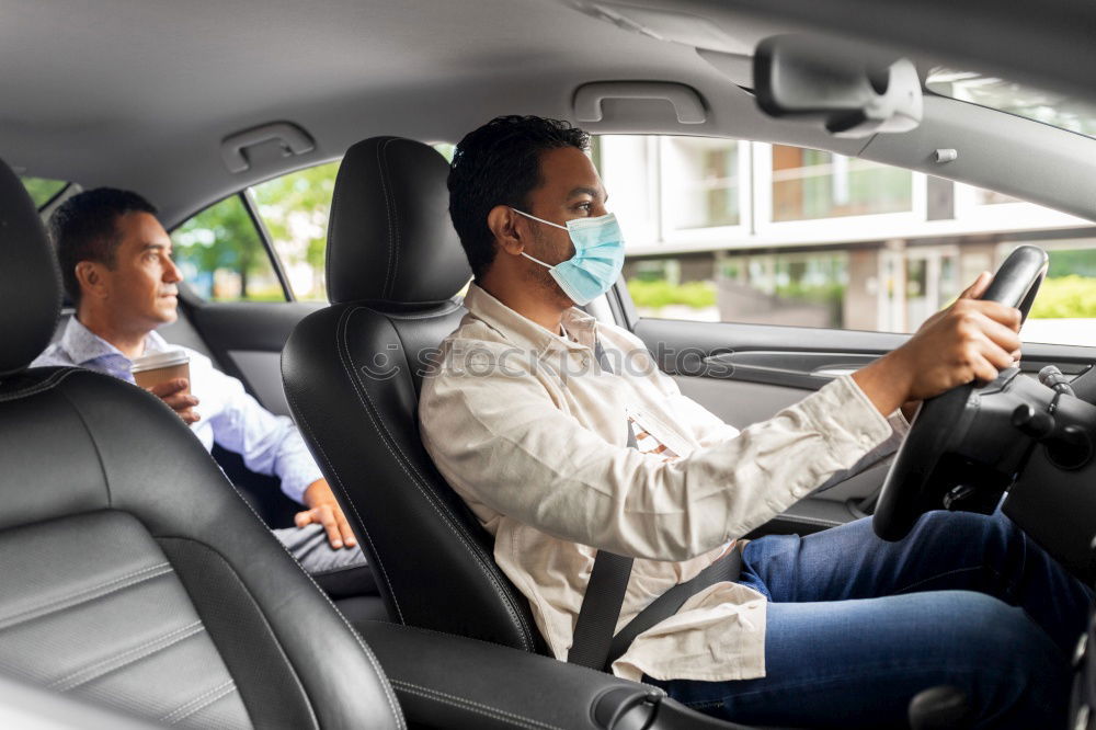 Similar – Taxi driver in a mask with a client on the back seat wearing mask