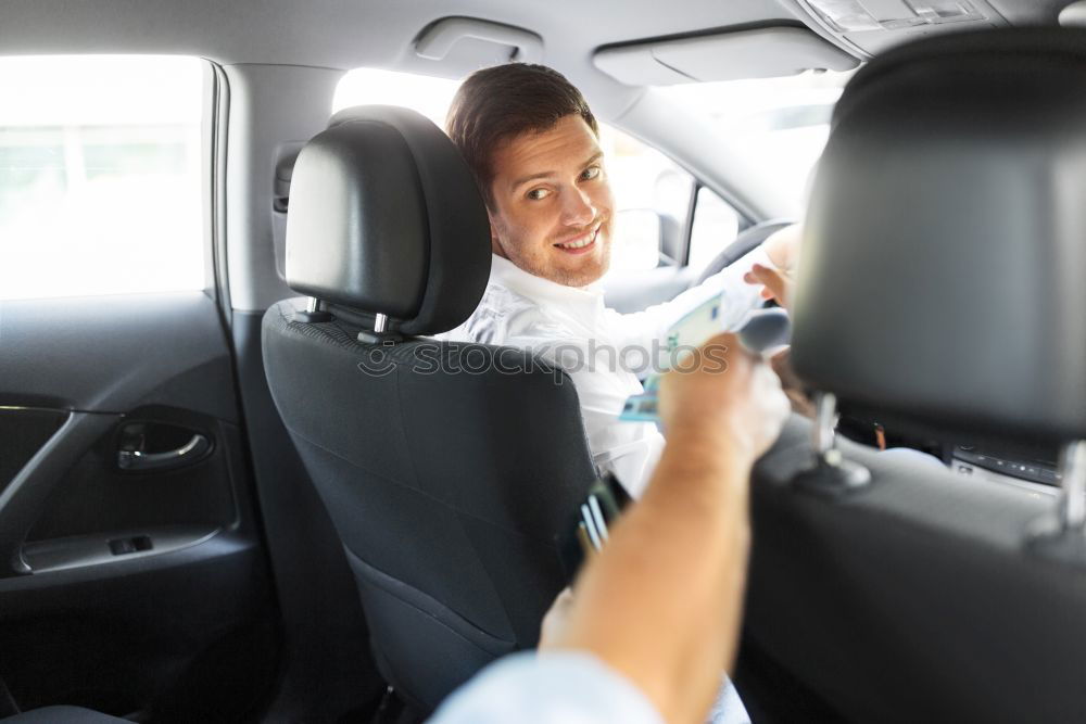 Similar – Taxi driver in a mask with a client on the back seat wearing mask