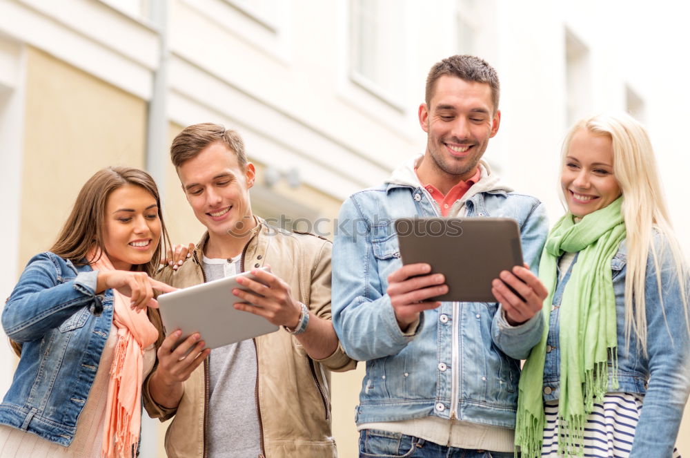 Similar – Multi-ethnic group of people looking at a tablet computer