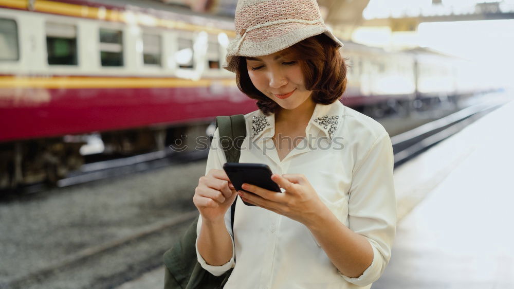 Similar – Image, Stock Photo Young woman with mobile phone at train station