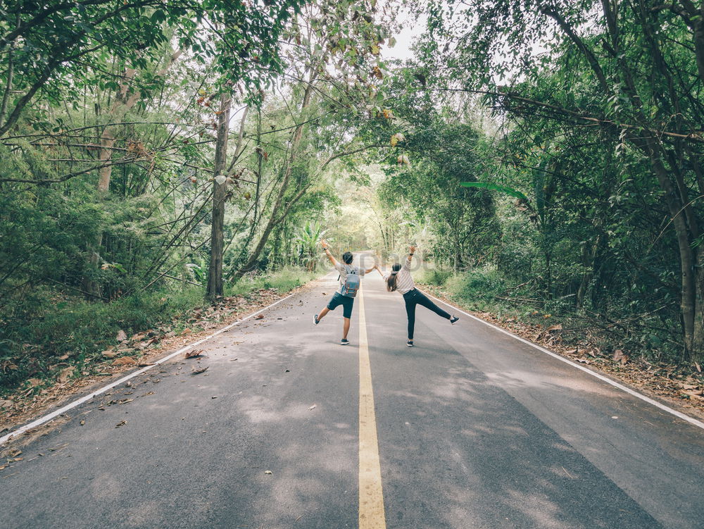 Similar – Image, Stock Photo Young adult group of friends riding longboards on road together